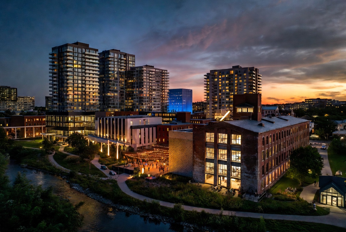 Heritage mill courtyard at dusk with mill bays lit