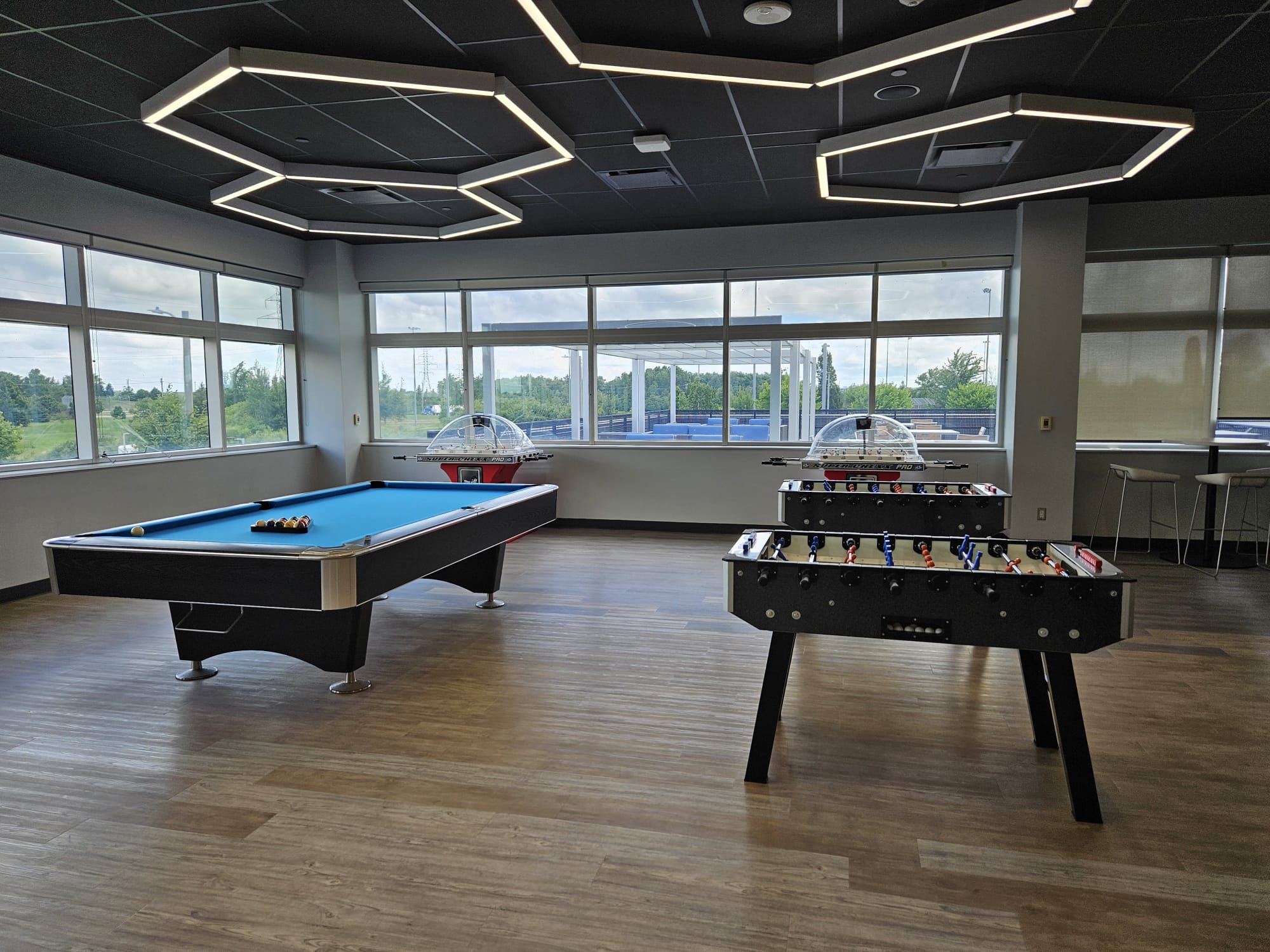 Render of village wellness and longevity centre with fitness floors, recovery pools, and natural light